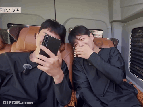 A Man Taking A Selfie With Another Man Covering His Face GIF