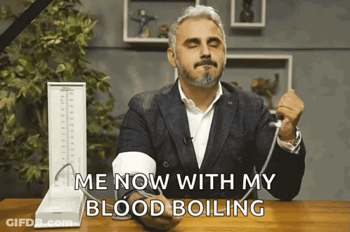 A Man Taking His Blood Pressure With The Words Me Now With My Blood Boiling Above Him GIF