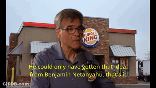 A Man Talking In Front Of A Burger King GIF