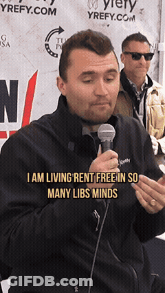 A Man Talking Into A Microphone With The Words " I Am Living Rent Free In So Many Libs Minds " GIF