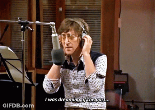 A Man Talking Into A Microphone With The Words " I Was Dreaming Of The Past " Below Him GIF