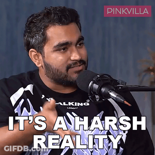 A Man Talking Into A Microphone With The Words " It 'S A Harsh Reality " Written Below Him GIF