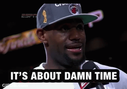 A Man Talking Into A Microphone With The Words " It 'S About Damn Time " Below Him GIF