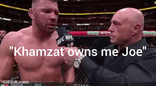 A Man Talking Into A Microphone With The Words " Khamzat Owns Me Joe " GIF