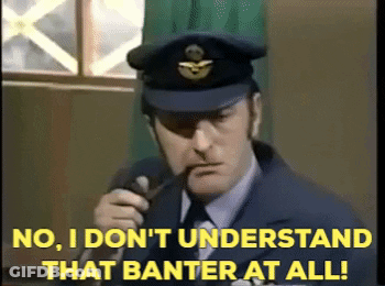 A Man Talking Into A Microphone With The Words No I Don 'T Understand That Banter At All Behind Him GIF
