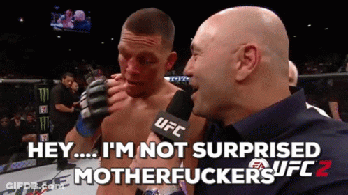 A Man Talking Into A UFC Microphone While Another Man Watches GIF