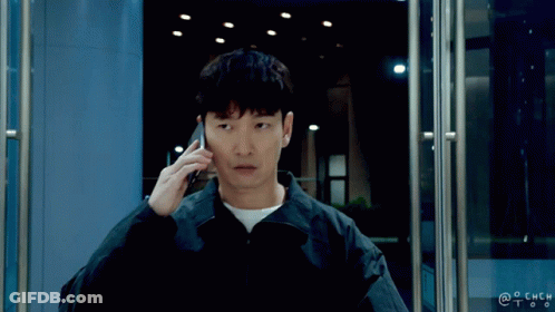 A Man Talking On A Cell Phone In Front Of A Door With A Watermark That Says @Chch GIF