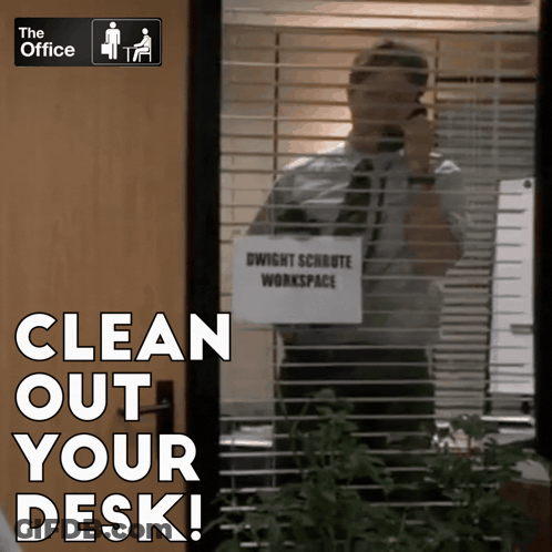 A Man Talking On A Cell Phone In Front Of A Sign That Says " Clean Out Your Desk " GIF