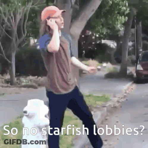 A Man Talking On A Cell Phone Next To A Fire Hydrant With The Words So No Starfish Lobbies Below Him GIF