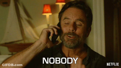 A Man Talking On A Cell Phone With The Word Nobody Written Below Him GIF