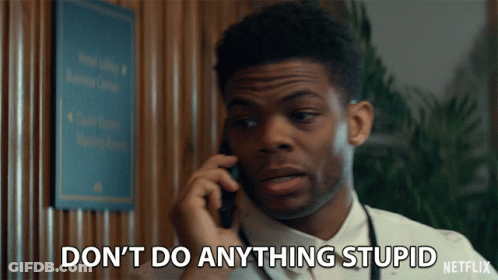 A Man Talking On A Cell Phone With The Words " Do N't Do Anything Stupid " Written Below Him GIF