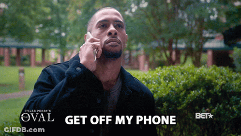 A Man Talking On A Cell Phone With The Words " Get Off My Phone " Above Him GIF