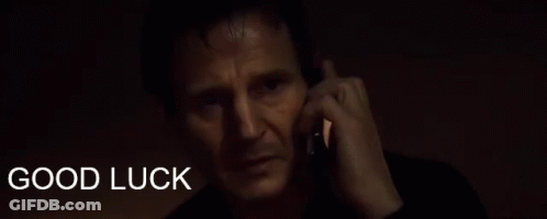 A Man Talking On A Cell Phone With The Words " Good Luck " Behind Him GIF