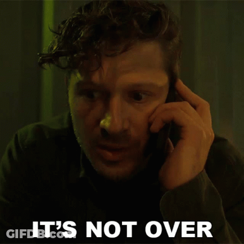A Man Talking On A Cell Phone With The Words " It 'S Not Over " Behind Him GIF