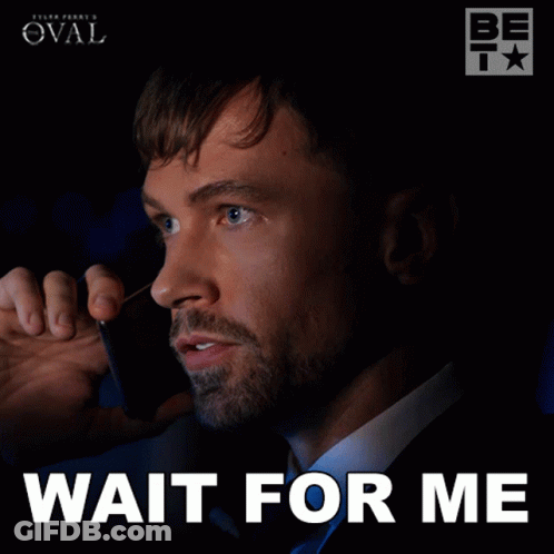 A Man Talking On A Cell Phone With The Words Wait For Me Written Below Him GIF