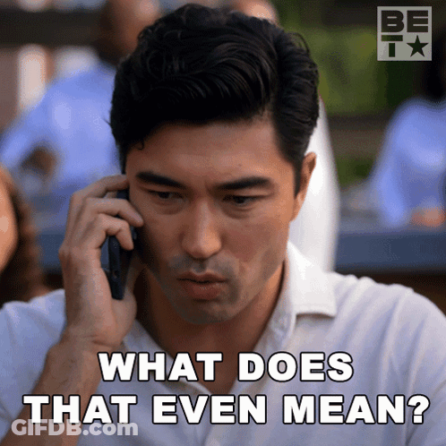 A Man Talking On A Cell Phone With The Words " What Does That Even Mean " Below Him GIF
