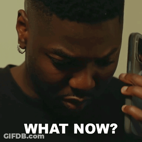 A Man Talking On A Cell Phone With The Words " What Now " Written Below Him GIF