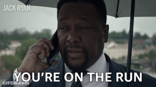 A Man Talking On A Cell Phone With The Words You 'Re On The Run GIF