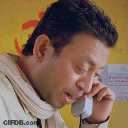 A Man Talking On A Phone With A Sign Behind Him That Says " If You Want To We Have Design " GIF