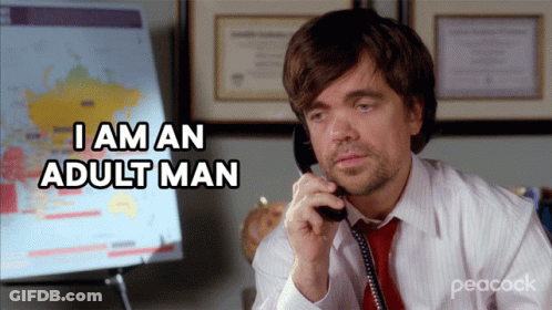 A Man Talking On A Phone With The Words I Am An Adult Man Behind Him GIF