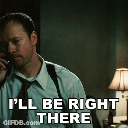 A Man Talking On A Phone With The Words I 'Ll Be Right There Written Below Him GIF