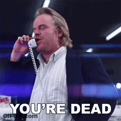 A Man Talking On A Phone With The Words You 'Re Dead Written Below Him GIF