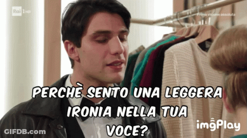 A Man Talking To A Woman With The Words Perche Sento Una Leggera Ironia Nella Tua Voce Behind Him GIF