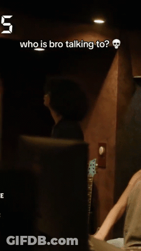 A Man Talking To Another Man In A Dark Room With The Number 5 Above Him GIF