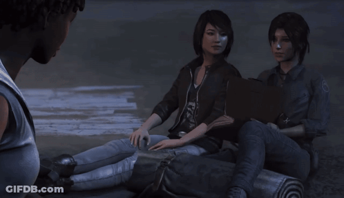 A Man Talks To Two Girls Sitting On A Log GIF