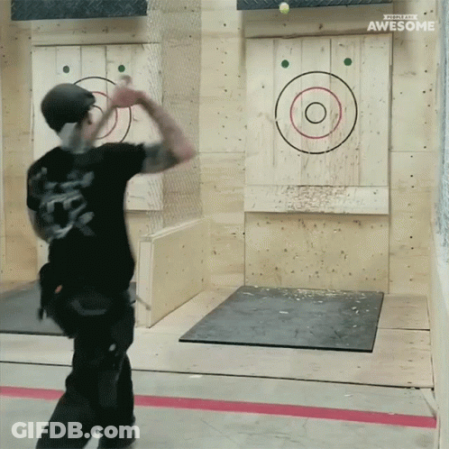 A Man Throws An Axe At A Target That Says Awesome On The Bottom GIF