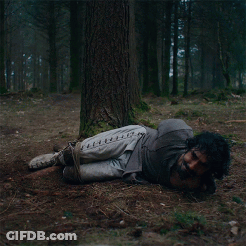 A Man Tied To A Tree With Stitches On His Pants GIF