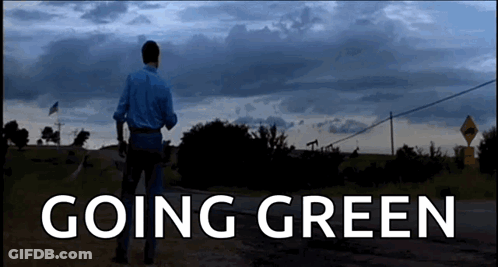 A Man Walking Down A Dirt Road With The Words " Going Green " On The Bottom GIF