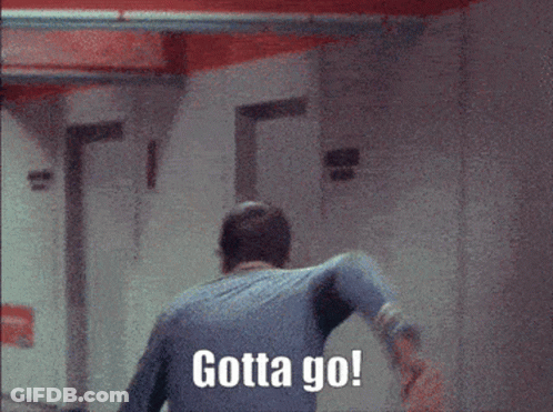 A Man Walking Down A Hallway With Gotta Go Written On The Wall Behind Him GIF