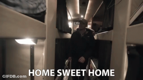 A Man Walking Down A Hallway With The Words Home Sweet Home Above Him GIF