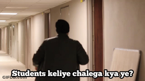 A Man Walking Down A Hallway With The Words Students Keliye Chalaga Kya Ye GIF