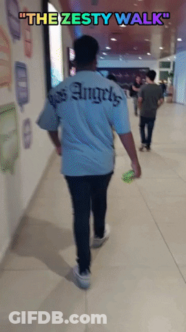 A Man Walking Down A Hallway With The Words " The Zesty Walk " Above Him GIF