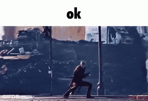 A Man Walking Down A Street With The Word Ok On The Bottom GIF