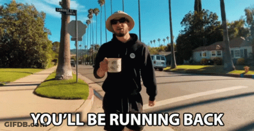 A Man Walking Down A Street With The Words " You 'Ll Be Running Back " Below Him GIF