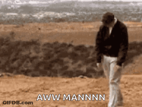 A Man Walking In The Desert With The Words Aww Mannn On The Bottom Right GIF