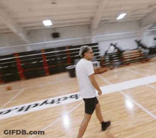 A Man Walking On A Basketball Court With The Word Barych Written On The Floor GIF