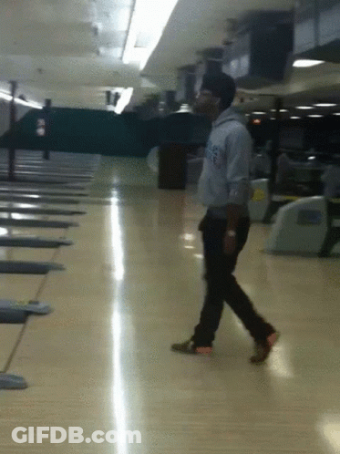 A Man Walking On A Bowling Alley Wearing A Sweatshirt That Says Los Angeles On It GIF