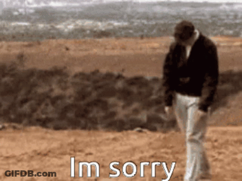 A Man Walking On A Dirt Road With The Words I 'M Sorry Written Below Him GIF