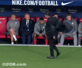 A Man Walking On A Soccer Field In Front Of A Nike.com/football Banner GIF