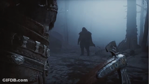 A Man Walking Through A Foggy Forest With A Sword GIF