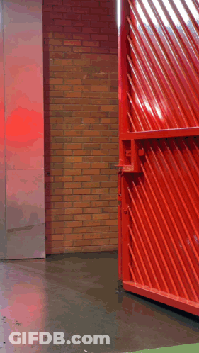 A Man Walking Through A Red Gate With The Words " Good Morning " On The Bottom GIF