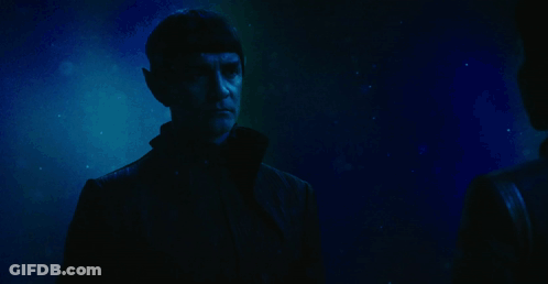 A Man Waves His Hand With The Words Live Long Behind Him GIF