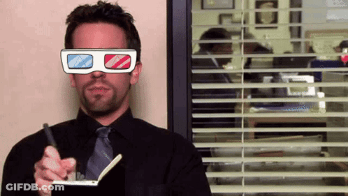 A Man Wearing 3D Glasses Is Holding A Pen And Writing In A Notebook GIF