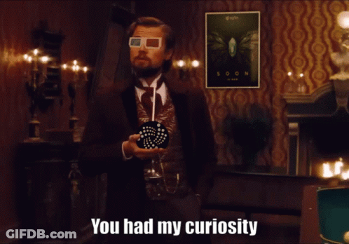 A Man Wearing 3D Glasses Stands In Front Of A Soon Poster GIF