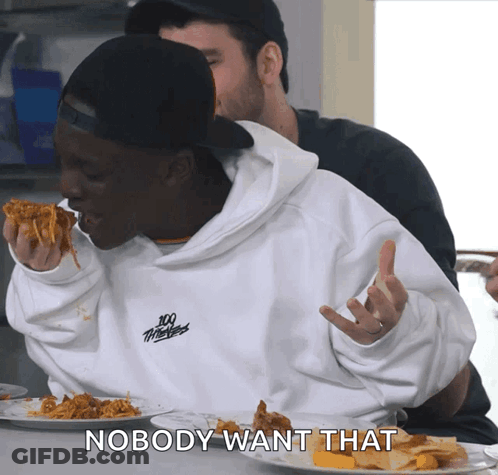 A Man Wearing A 100 Thieves Sweatshirt Is Eating A Slice Of Pizza GIF