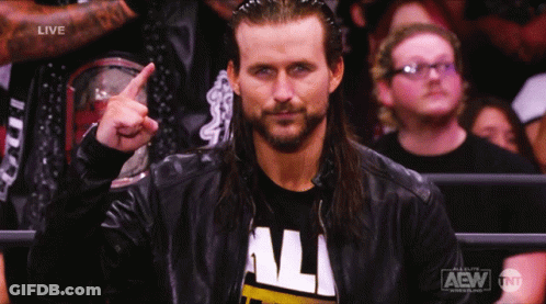 A Man Wearing A Aew Shirt Is Pointing Up GIF